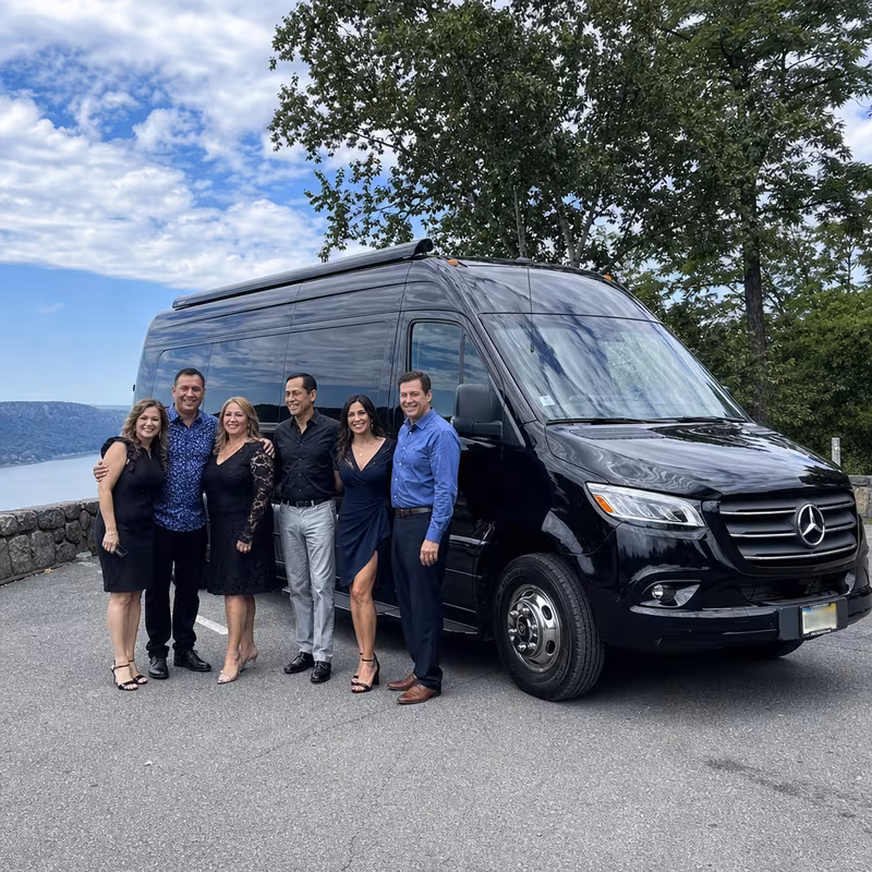 Group beside a Mercedes Sprinter limo from the Fort Lee fleet
