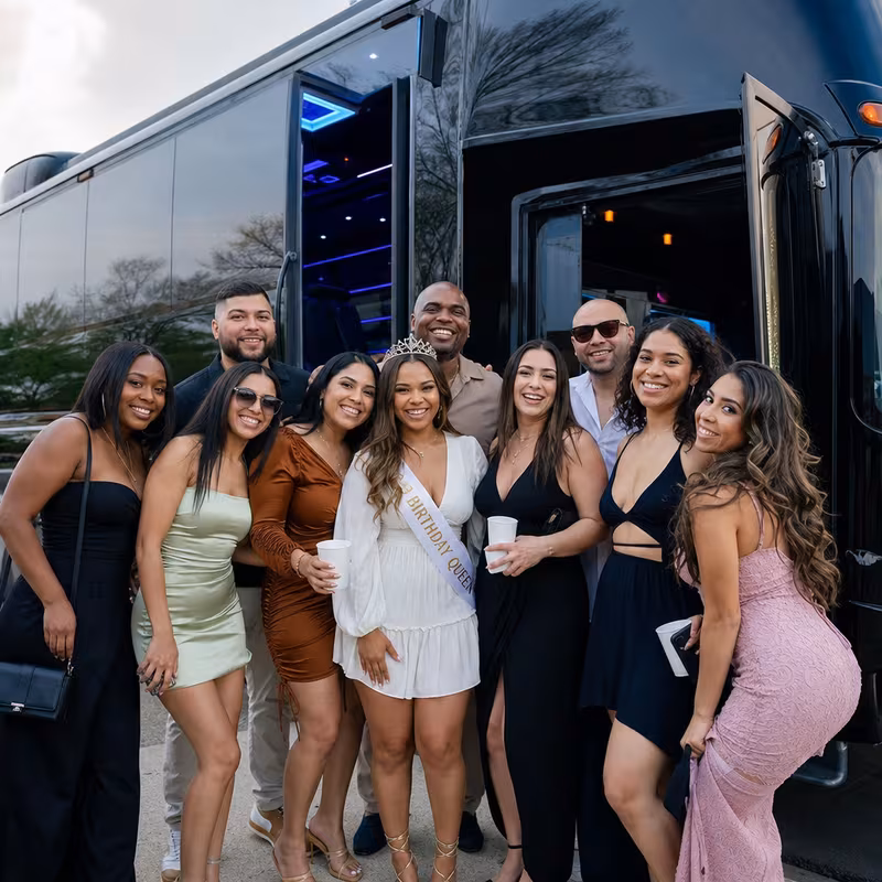 Group boarding a white charter bus for Birthday Transportation transportation in Fort Lee