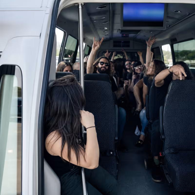 Party bus interior with wraparound leather seating and LED lighting in Fort Lee