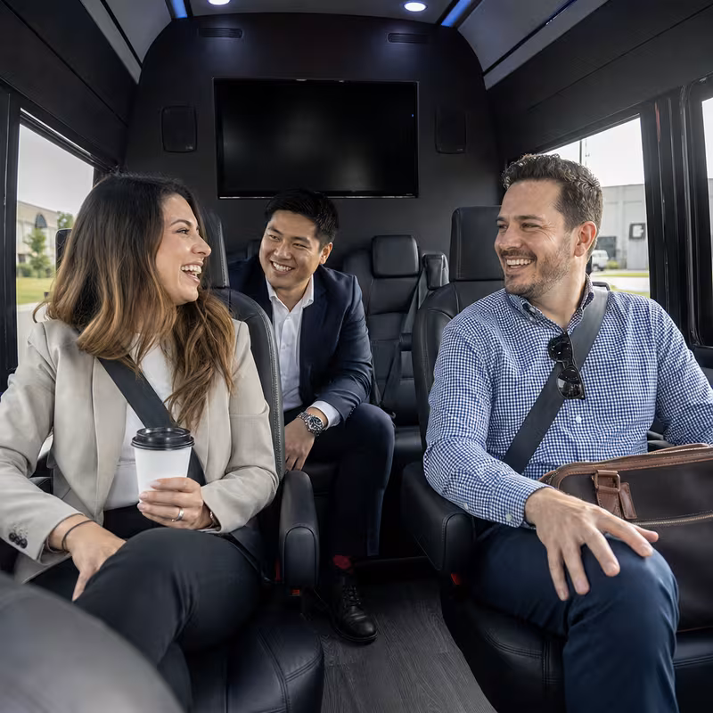 Group boarding a white charter bus for Corporate Transportation transportation in Fort Lee