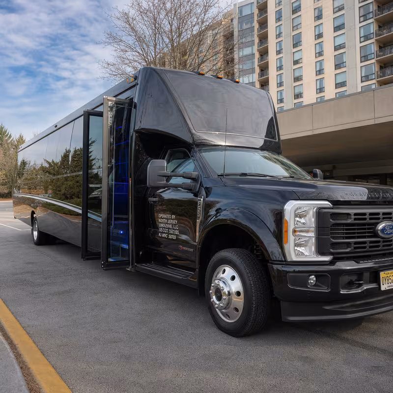 Party bus interior with wraparound leather seating and LED lighting in Fort Lee