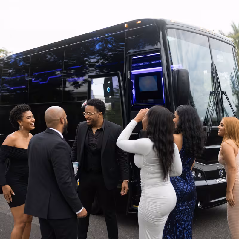 Passengers loading luggage while boarding an Fort Lee group shuttle