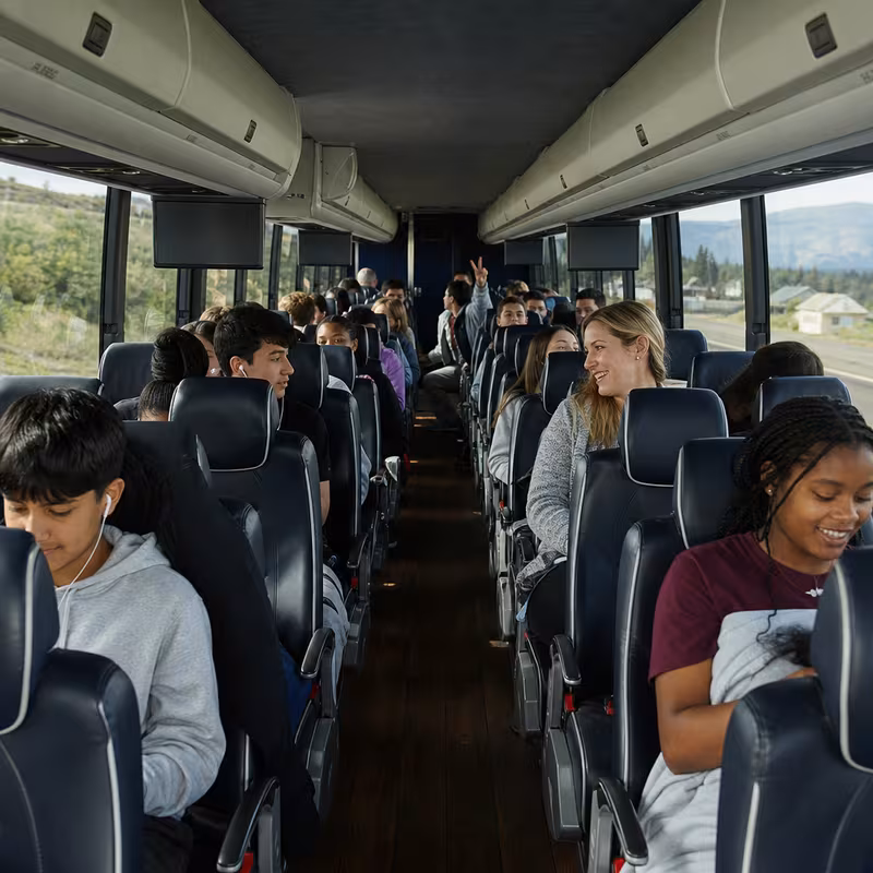 Group boarding a white charter bus for School Transportation transportation in Fort Lee
