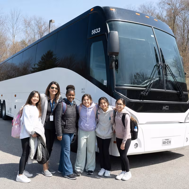Passengers loading luggage while boarding an Fort Lee group shuttle