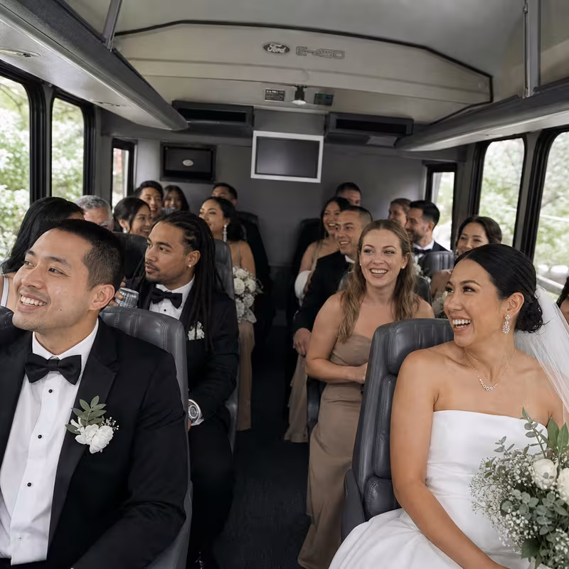 Group boarding a white charter bus for Wedding Transportation transportation in Fort Lee