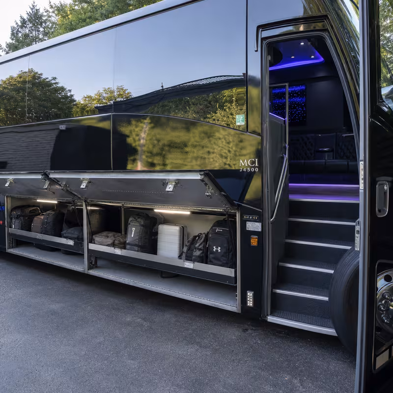 Party bus interior with wraparound leather seating and LED lighting in Fort Lee