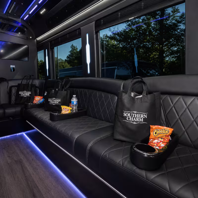 Party bus interior with wraparound leather seating and LED lighting in Fort Lee